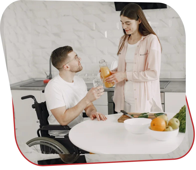 Participant in a wheelchair preparing food in an accessible kitchen